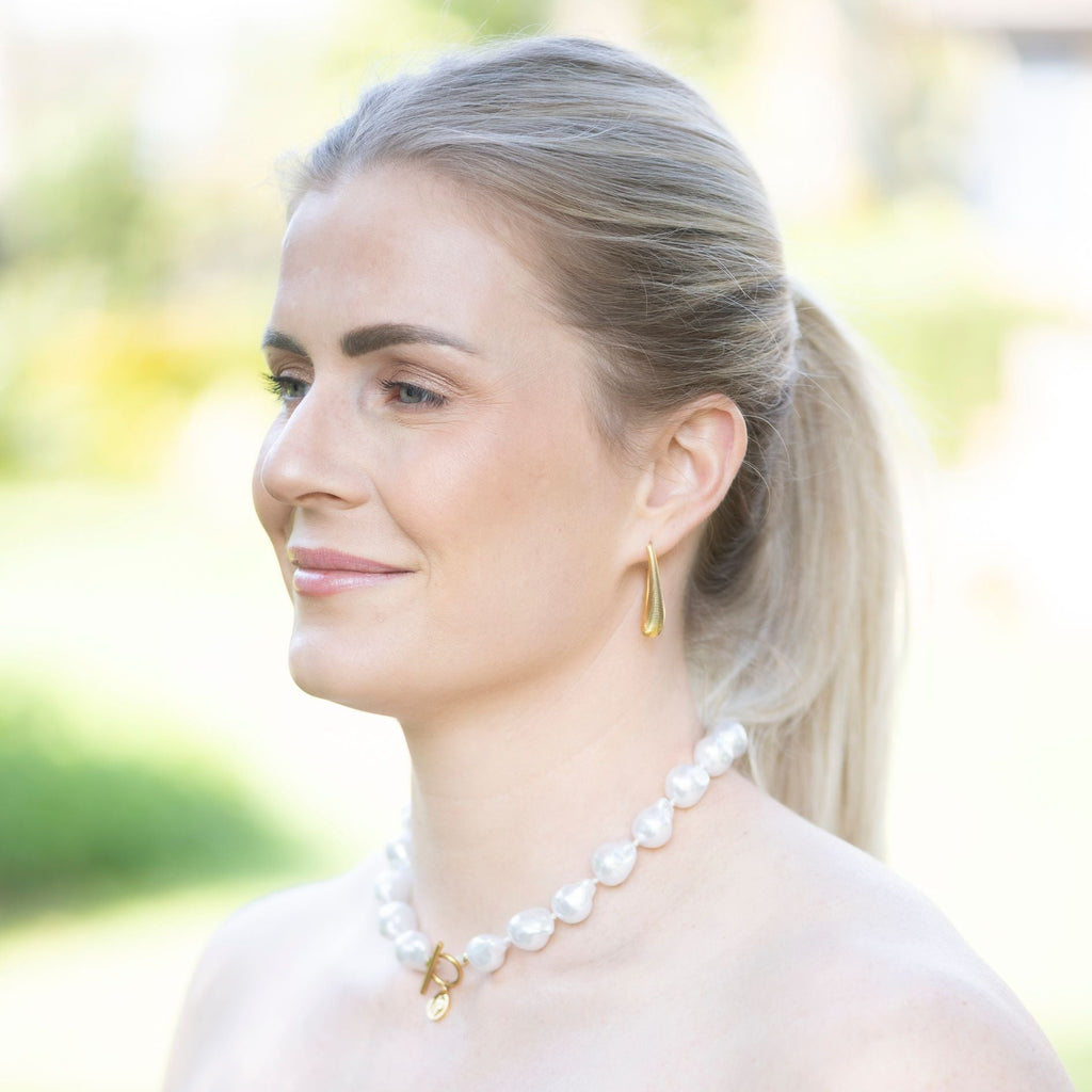 Woman wearing a pearl necklace outdoors
