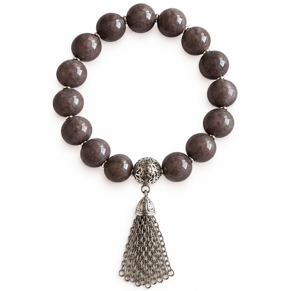 Colours of Fabulous Paloma Tassel Bracelet grey beads with silver chain tassel on white background